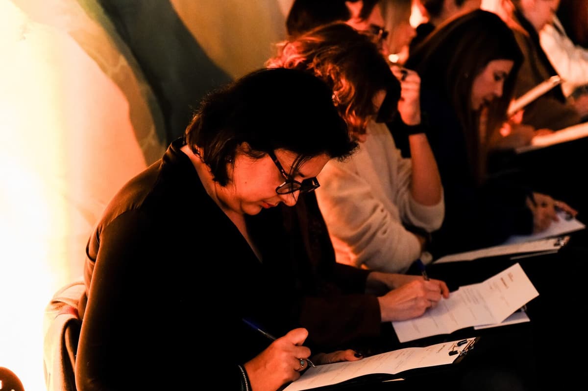 Participants writing on questionnaires