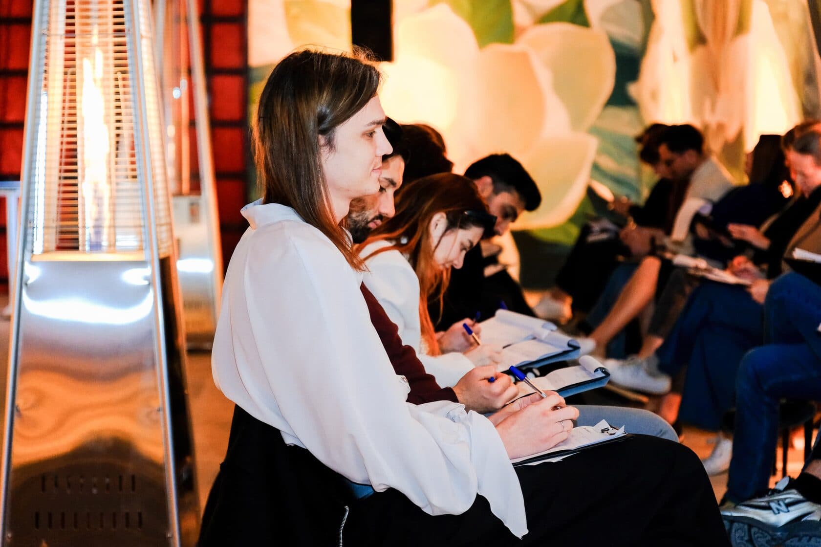 Row of people observing and writing