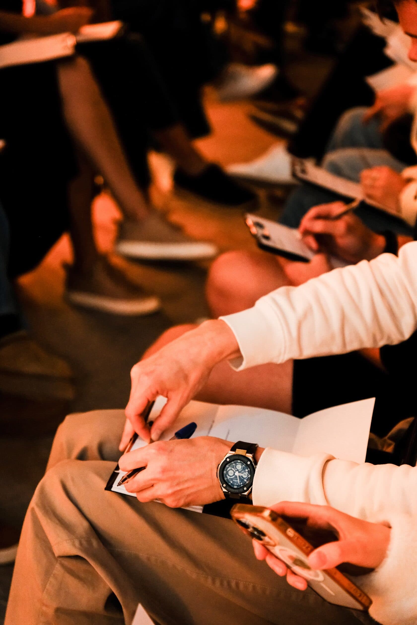 Hands writing on questionnaires